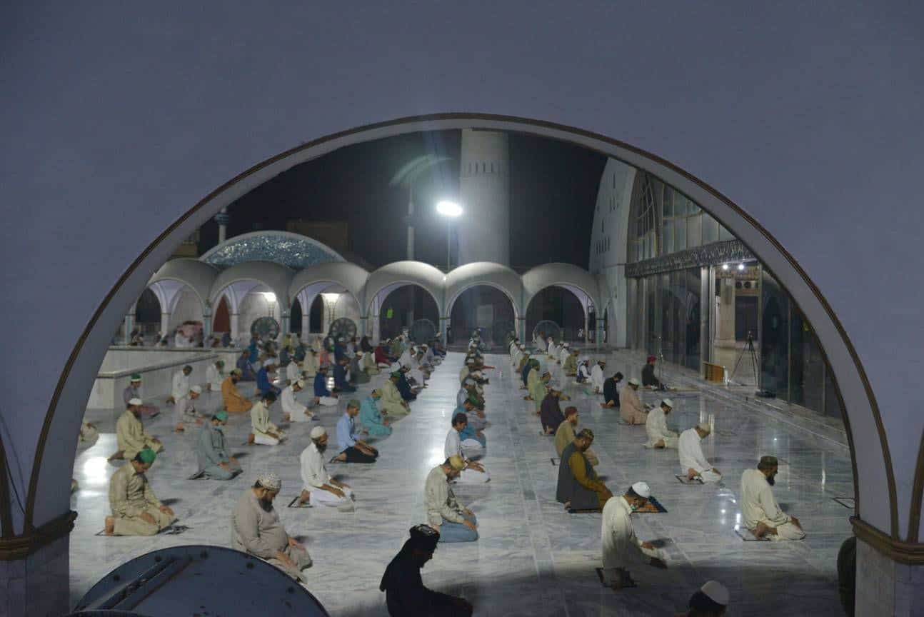 Pakistani faithful Muslims offer the first night prayer called Tarawih after seeing the moon of the fasting month of Ramadan during a national blockade imposed by the government in Lahore