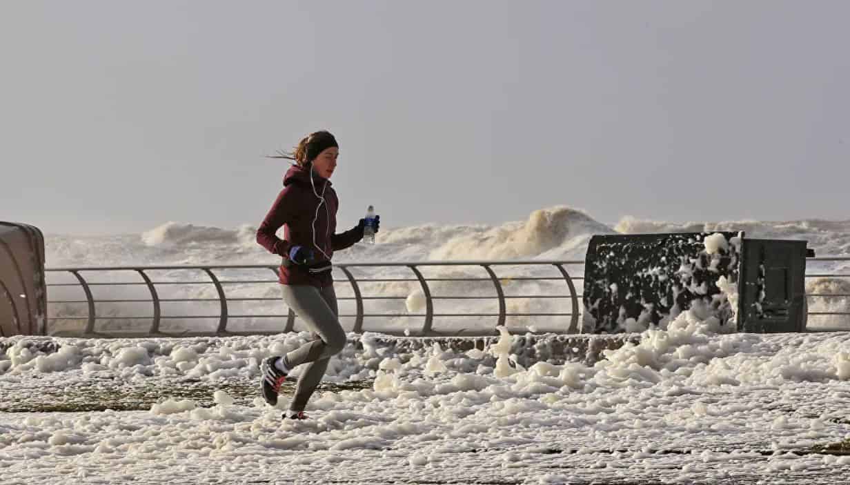 a young woman runs in Blackpool, in the northwest of England.