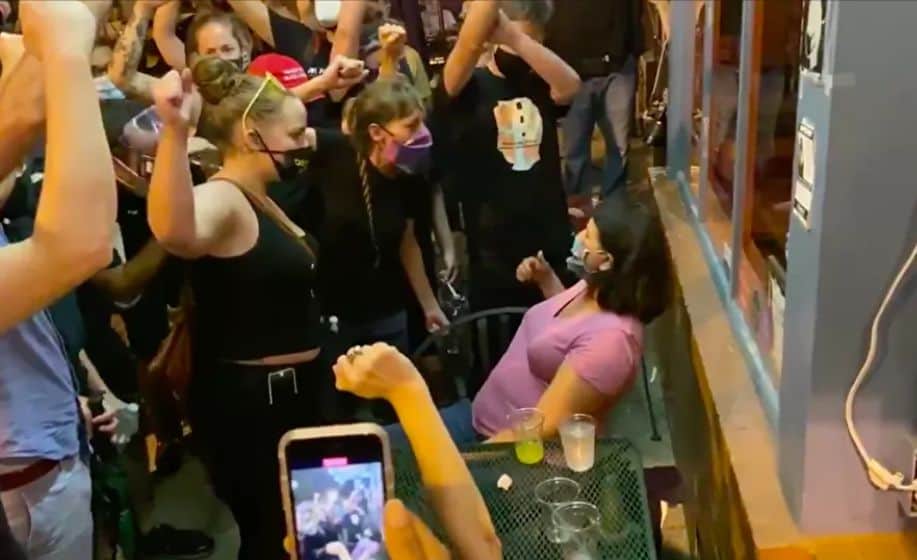 Aggressive protesters intimidate a woman in a restaurant in Washington